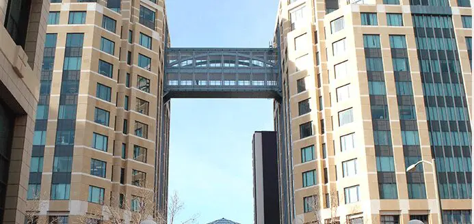 A large bridge is going through the center of this building.