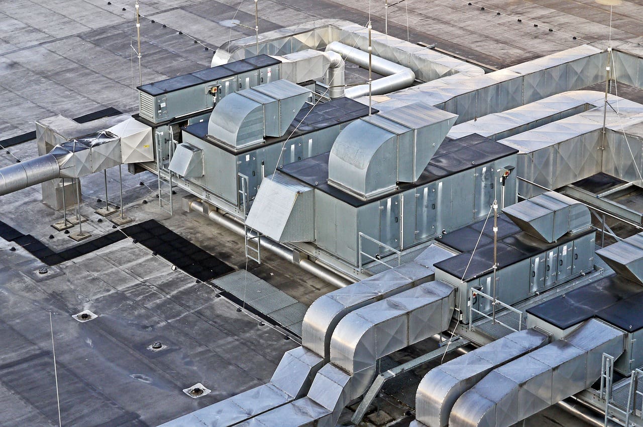 A view of an industrial building with many air vents.